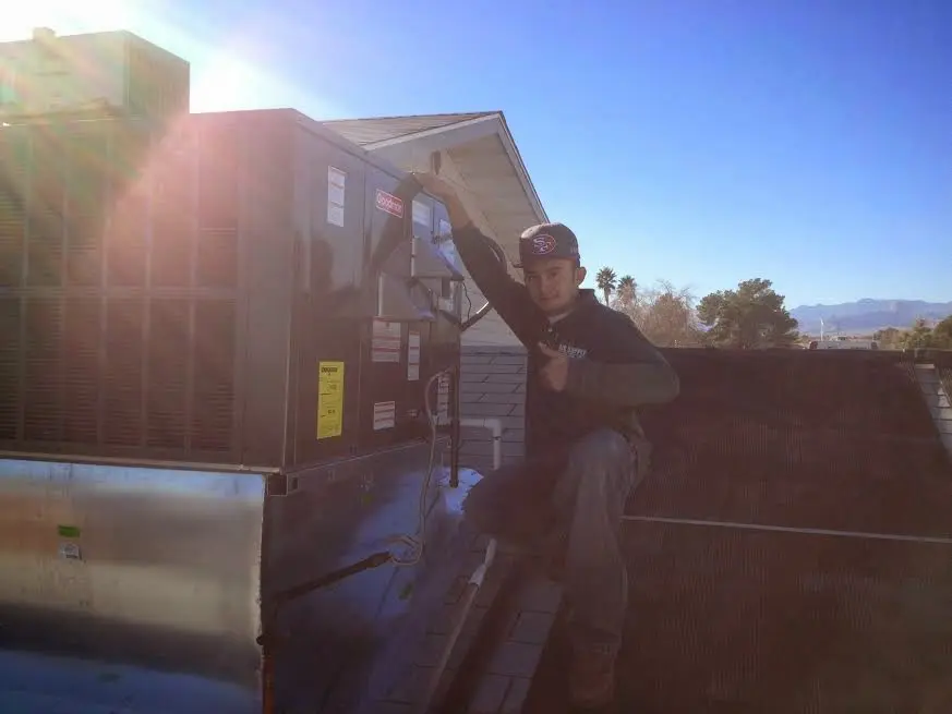 HVAC technician performing Heat Pump Repair on a rooftop unit in Mount Pleasant